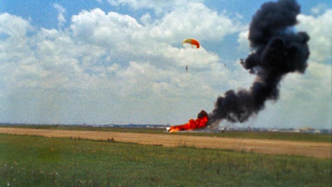 This 1968 NASA photo shows Neil Armstrong parachuting out of an aircraft simulating the lunar landing module just before it crashed and exploded. A permit for filming of a movie about Armstrong in Perry states the scene is recreating a crash with a fire.