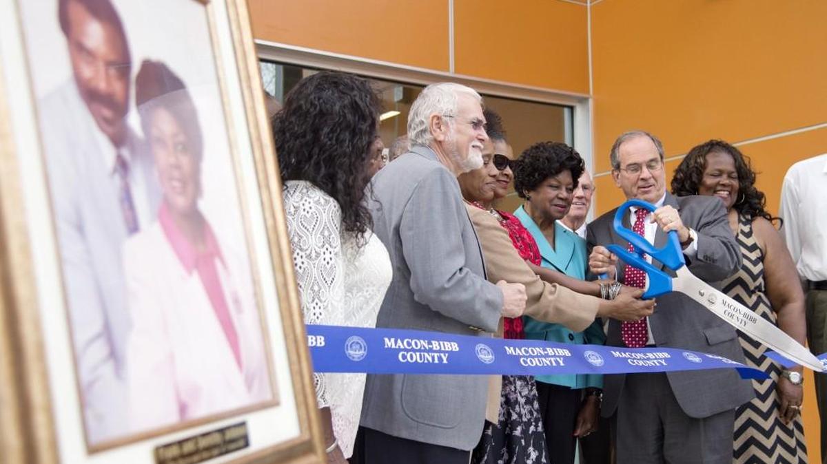Macon-Bibb County mayor Robert Reichert helps Dorothy Johnson cut a ribbon during the reopening of Frank Johnson Recreation Center Monday.