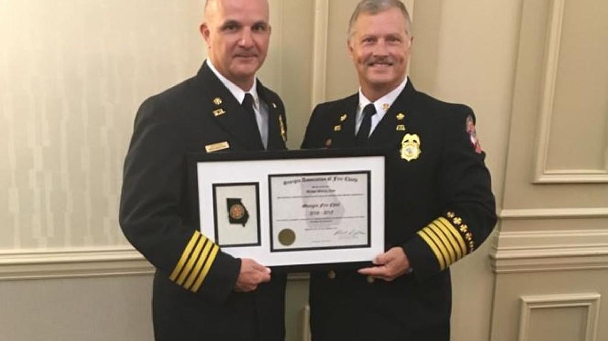 Deputy Chief Ross Moulton, left, of the Warner Robins Fire Department, was one of the first in the state to be certifed with the Georgia Association of Fire Chiefs. Chief Robert Singletary, right, also attended Saturday’s awards ceremony in Augusta.