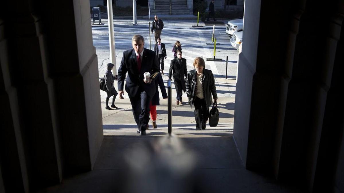 Legislators and Statehouse workers walk into the Georgia Capitol for the first day of the legislative session in Atlanta, Monday, Jan. 9. The House and Senate convened Monday morning with the swearing-in of lawmakers. Before leaving the Capitol, top lawmakers will hear from businesses pushing for less red tape, among other issues.