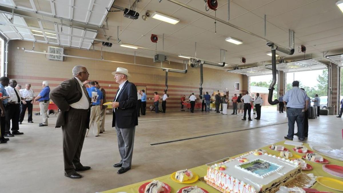 Bibb County Commission chairman Sam Hart and Sheriff David Davis share cake after July 12, 2013 dedication ceremonies for the new station on New Forsyth Road.