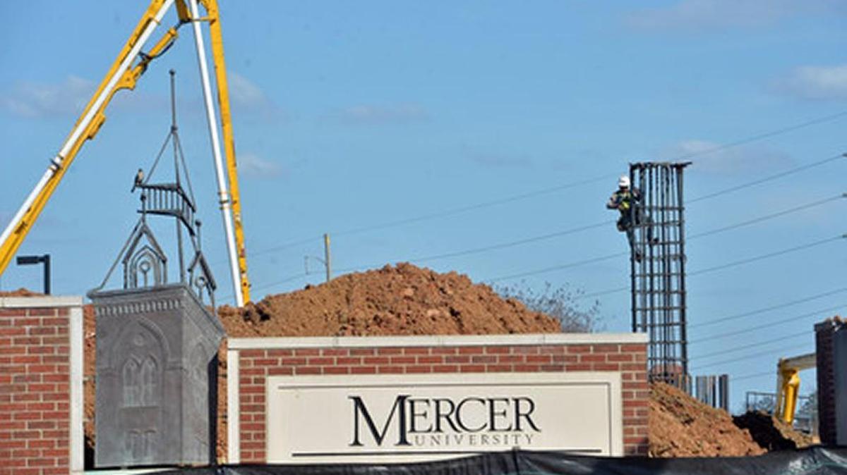 In March, workmen were tying rebar on a tower that will support a walkway over Mercer University Drive and pouring concrete for its foundation. The walkway connects a mixed-use development with the Mercer University campus.