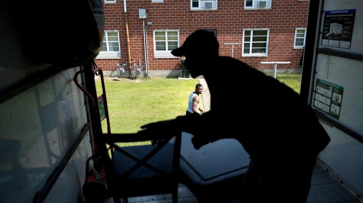 Kenny Howell Jr. looks back into the back of a moving truck as he relocates himself, his girlfriend and their three kids from the Tindall Heights housing project in Macon to a new rental house.