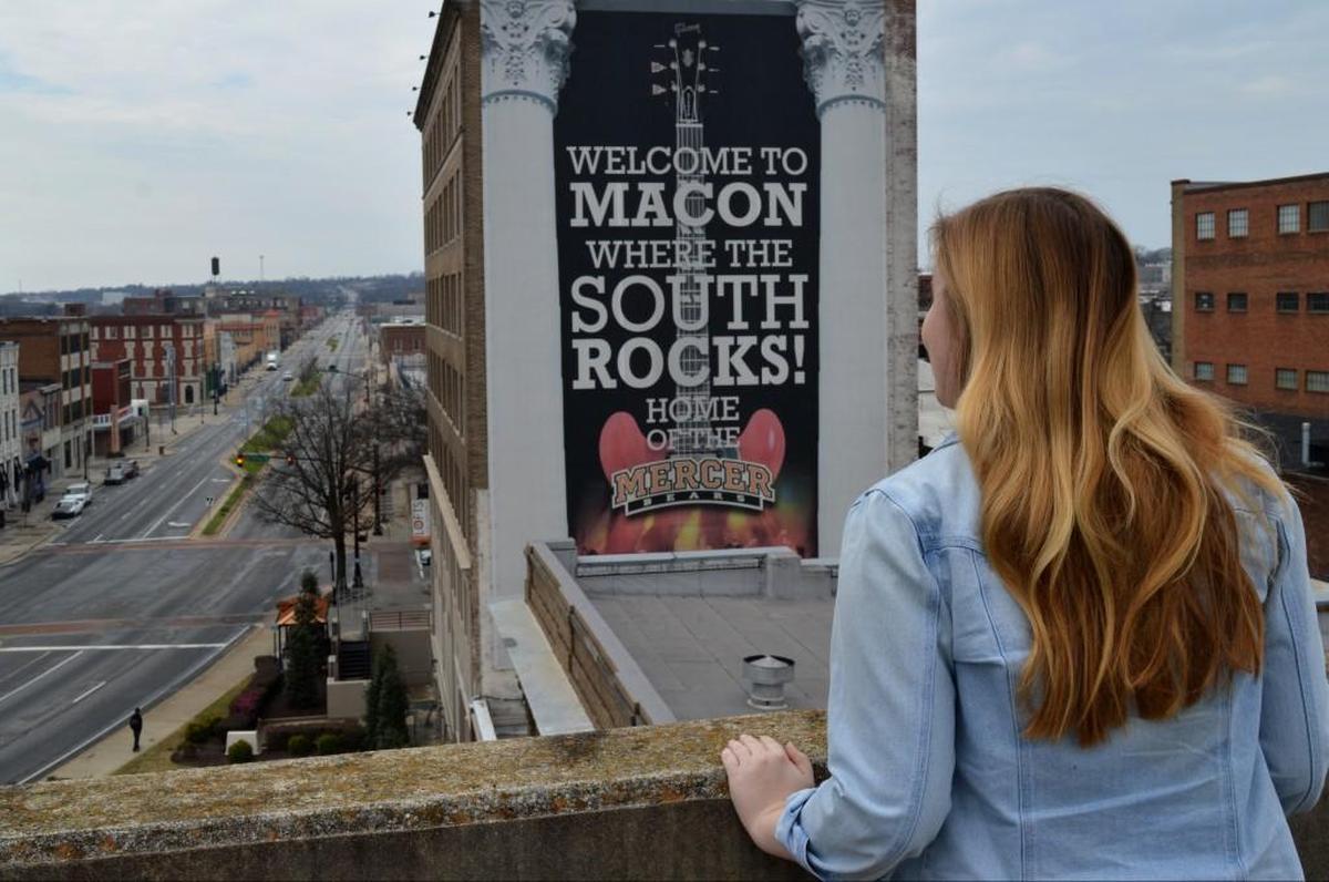 Elizabeth Tammi poses for a picture on top of the downtown parking garage for Georgia College & State University.