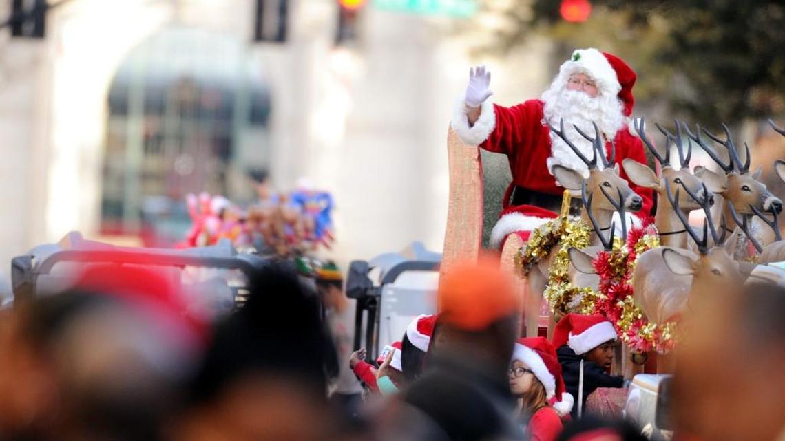 Santa Claus waves to onlookers sitting along Cherry Street during the Main Street Macon Christmas Parade on 12/06/2015.