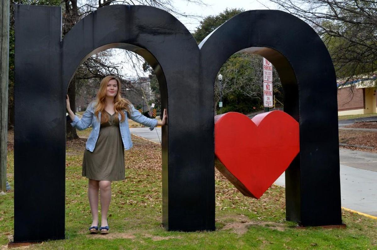 Elizabeth Tammi poses for a picture at the “I Love Macon” sculpture.