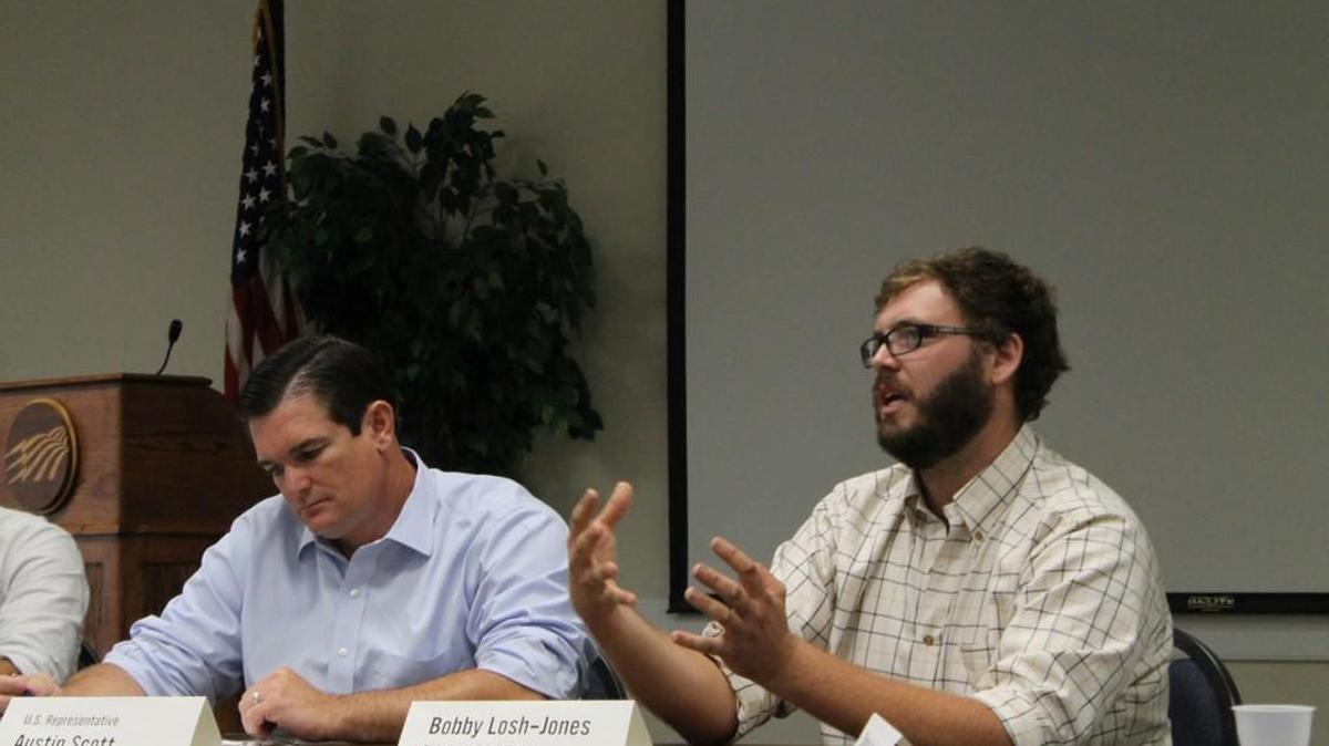 Bobby Losh-Jones, of Babe and Sage Farm in Gordon, tells U.S Rep. Austin Scott, R-Ga., about his community supported agriculture business. He and his wife, Chelsea, sell weekly boxes of vegetables and other farm foods, to a subscriber group of about 70 people.