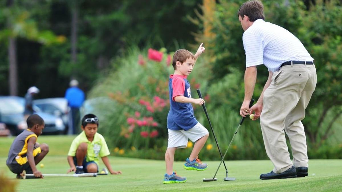In this July 22, 2013, Telegraph file photo, Idle Hour Club golf pro Ryan Ethridge, right, shares the finer points of putting with Junior Golf Academy participants at Bowden Golf Course.