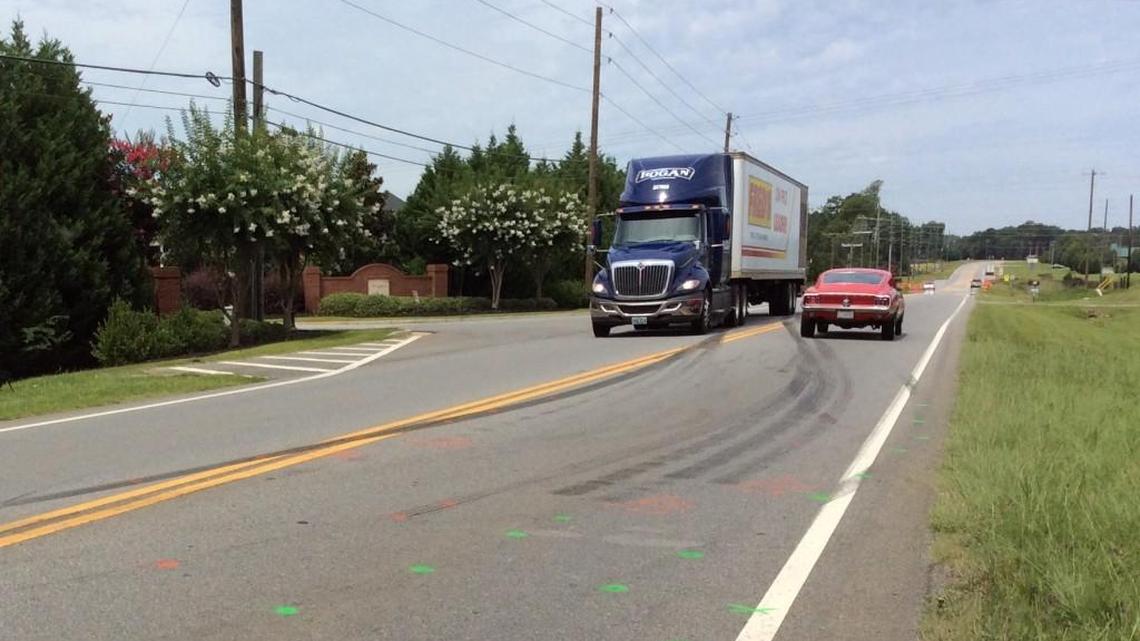 Skid marks on Ga. 96 show where a semi collided with a car pulling out of Hampton Meadows Drive, killing two people Monday evening near Bonaire Middle School.