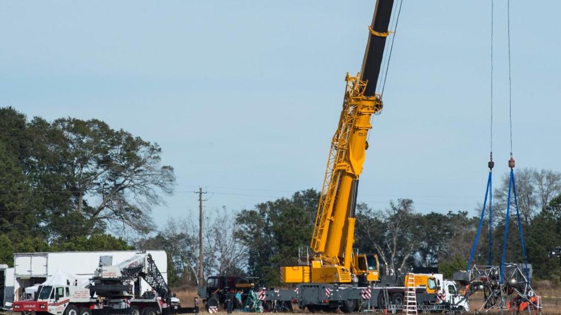A crane holds replica of a moon lander trainer that nearly killed Neil Armstrong in 1968, a year before he became the first man to walk on the moon. The scene is being recreated in Perry this week as part of a movie about Armstrong.
