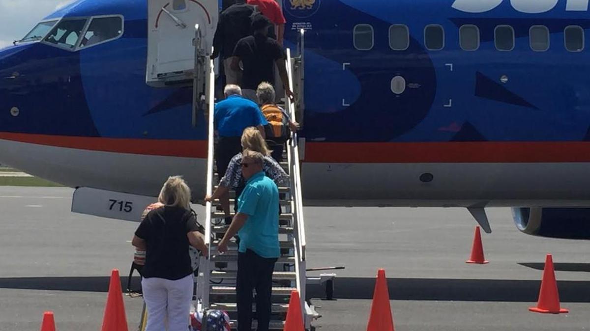 Middle Georgia Regional Airport passengers board a plan Friday departing to Biloxi, Mississippi.