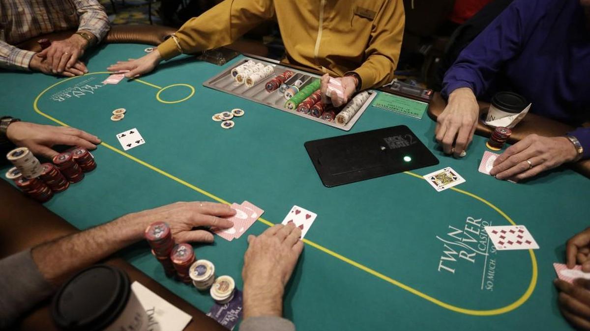 In this Wednesday, Feb. 3, 2016 photo a card dealer deals a game of poker to patrons at Twin River Casino, in Lincoln, R.I. Some Georgia lawmakers want to open the state to gaming, but they’ll face critics.