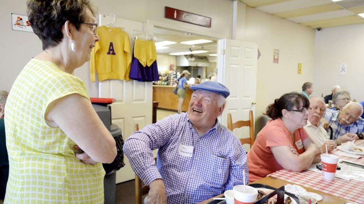 Former student Vic Armstrong speaks with Brenda Brannon during an Alexander III reunion at Fresh Air Barbecue Saturday afternoon. Brannon is helping to put together a reunion for the Masonic Home of Georgia Sunday.