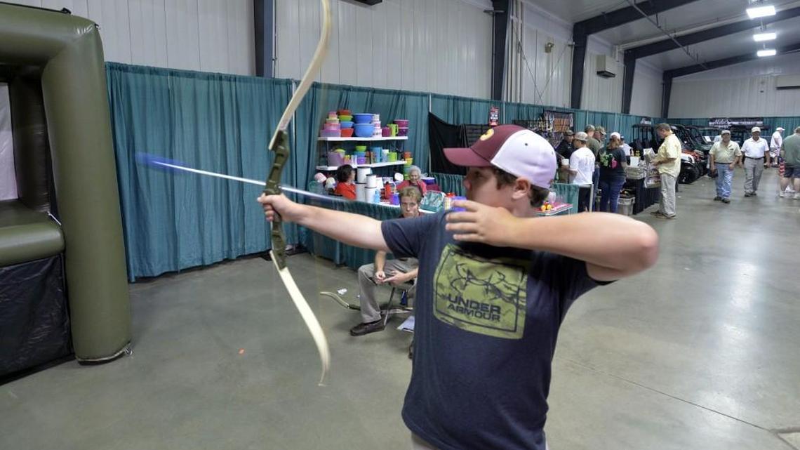 Perry Middle School student Sam Rodgers takes aim with a bow before knocking down a target at Buckarama in August, 2016. He said he's been hunting since before he bagged his first deer in third grade — but his weapon of choice is still a gun.