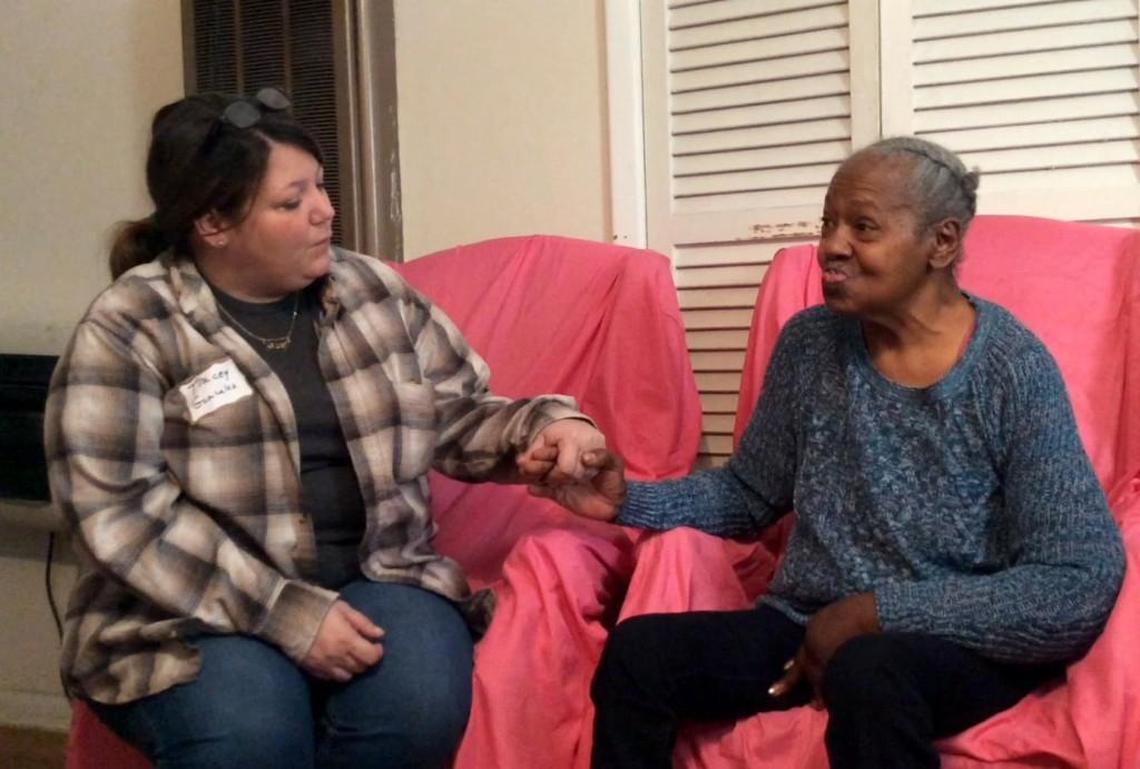 Tracy Gonzalez sits with Ruby Samples on Thanksgiving morning after delivering a turkey dinner from the Rescue Mission of Middle Georgia.