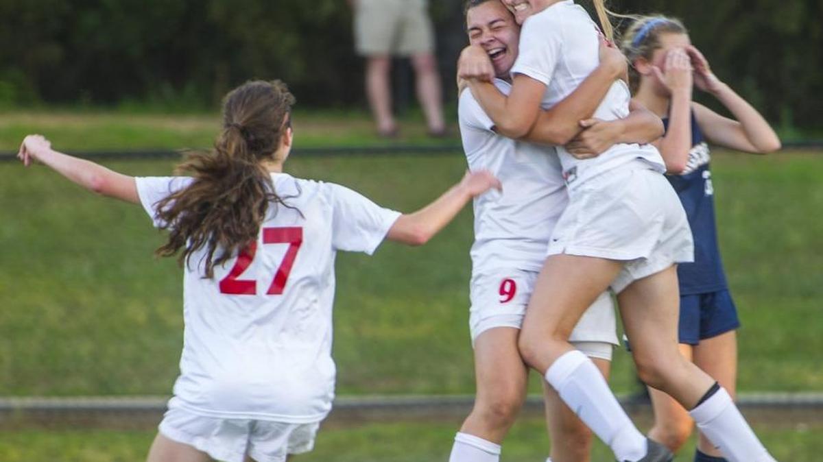 First place sports feature photo: First Presbyterian Day School's Sadie Frame (6) gets hugged by Maggie Johnston (9) after Frame made the only goal late in the first half of the match against Eagle's Landing.