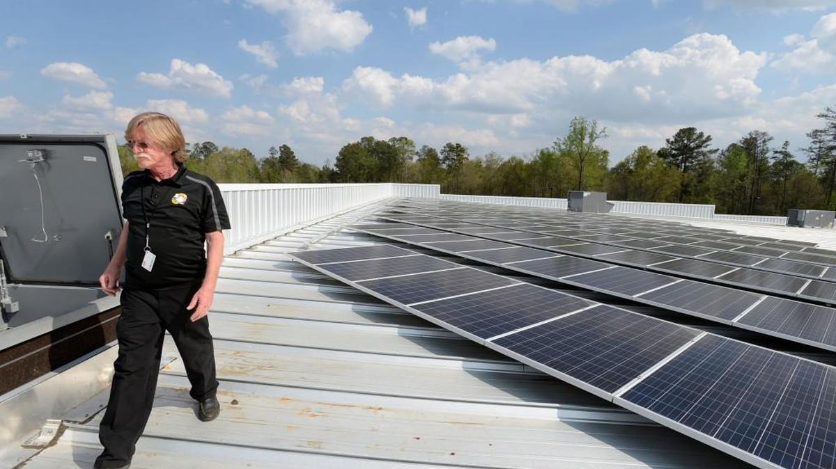 Pin Strikes facility engineer Will Ehlers says the solar panels mounted on the roof of the big building sometimes need a wash, but mainly keeping things clean is the key to capturing the sun's energy.