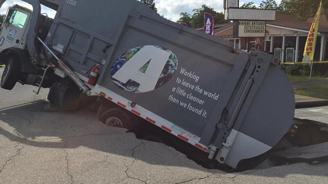According to an Augusta Fire/EMA Facebook post, the Advanced Disposal dump truck got stuck in the hole after the ground opened under the truck on Central Avenue early Thursday.