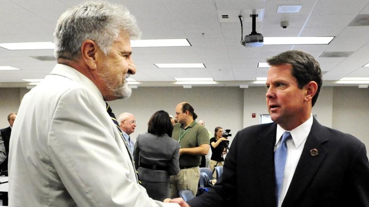 Secretary of State Brian Kemp, right, speaks with surveyor Terry Scarborough Aug. 23, 2011, after Kemp announced that he would not accept Scarborogh’s survey of the Bibb-Monroe county border. Kemp is expected to make a final ruling by the end of 2018.
