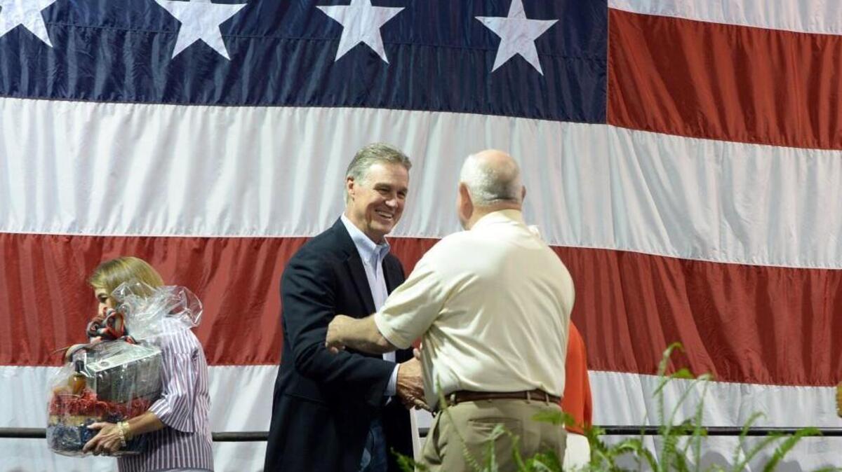 Mary Perdue and her husband, U.S. Secretary of Agriculture Sonny Perdue, make a hasty retreat after introducing his cousin, U.S. Senator David Perdue to the 8th Congressional District Fish Fry for Georgia Republicans.