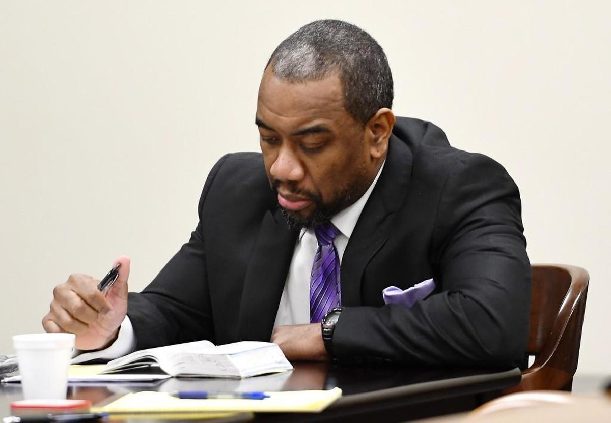 William C. Pounds III reads a Bible at the defense table as a jury deliberates Tuesday afternoon.