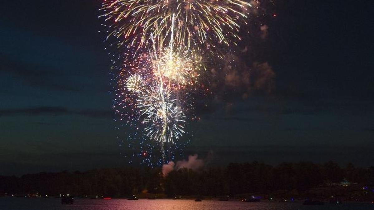Fireworks explode in the air over Sandy Beach at the Sparks Over the Park Independence Day Celebration at Lake Tobesofkee.