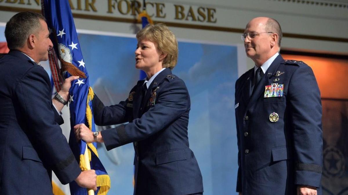 Air Force Chief of Staff Gen. David L. Goldfein (left) passes the flag of the Air Force Reserve Command to its new leader Lt. Gen. Maryanne Miller during ceremonies Friday at the Museum of Aviation. Outgoing Reserve Commander is Lt. Gen. James F. Jackson, right.