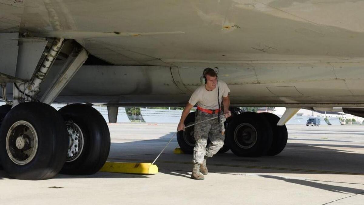 U.S. Air Force Airman 1st Class Thomas Love, with the 461st Aircraft Maintenance Squadron, removes chocks while launching an E-8C Joint STARS on a mission in support of Hurricane Harvey relief efforts, Robins Air Force Base, Ga., Sept. 1, 2017.