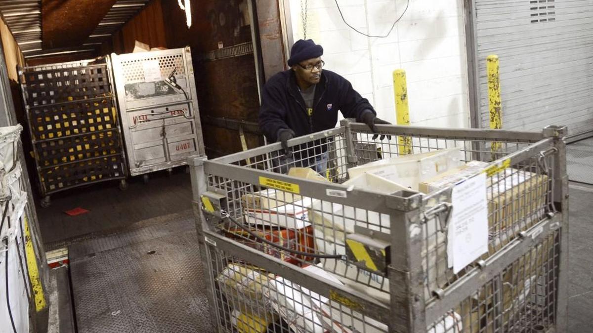 A mail contractor unloads a truck at the U.S. Postal Service processing distribution center on Holt Avenue in Macon in this Telegraph file photo.