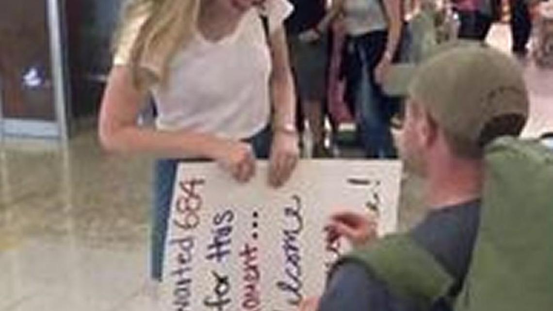 Cassie Bell, of Macon, accepts a marriage proposal from Austin Moore, of Warner Robins, who popped the question at Hartsfield Jackson International Airport in Atlanta in this screen grab from a WXIA-TV video.
