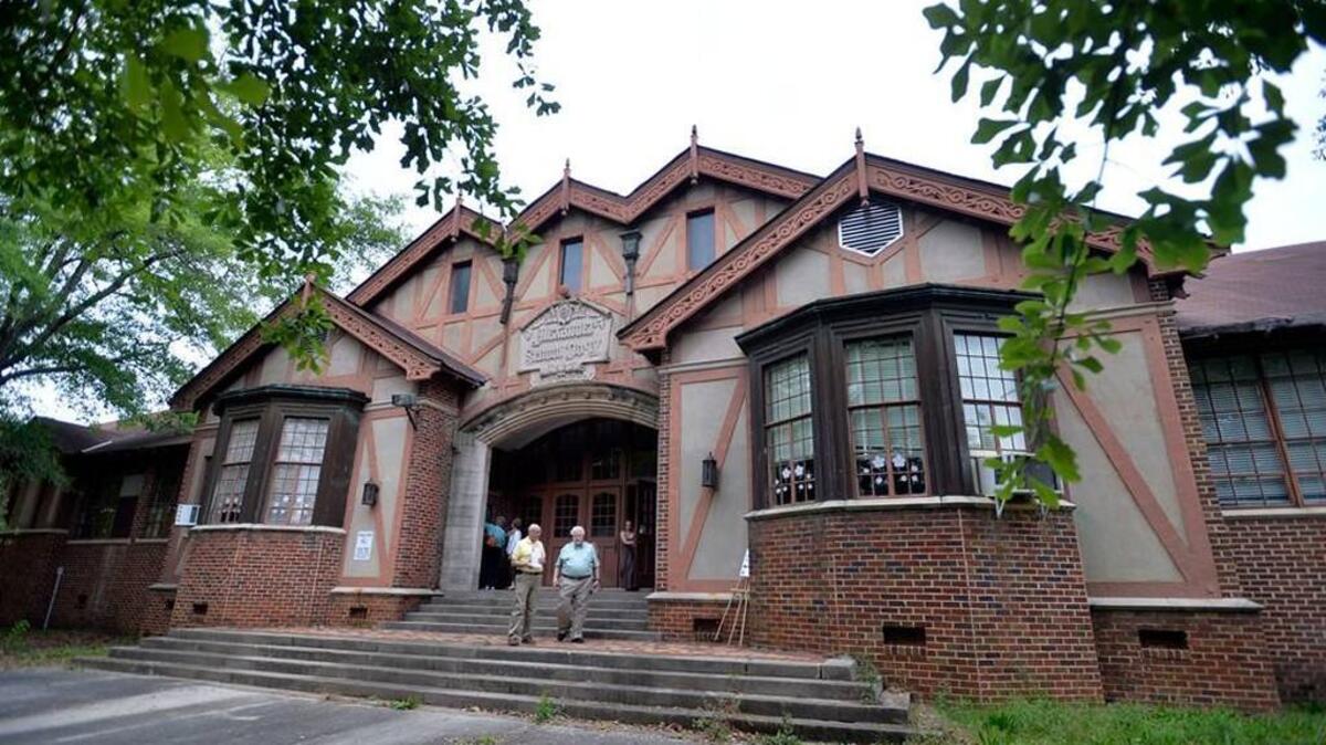People leave a meeting on April 11, 2016 where the public offered suggestions on how to reuse the Alexander IV school building. A developer has since proposed transforming the historic Macon building into an $8.8 million senior living facility.