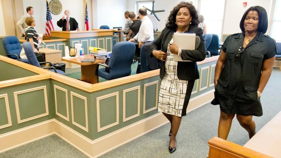 Gordon Mayor Mary Ann Whipple-Lue, left, walks out of a Wilkinson County courtroom after the conclusion of a trial to determine if Whipple-Lue will be removed from office.