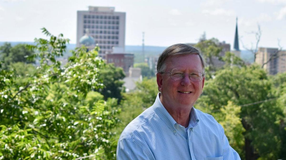 Ed Grisamore sits in front of the skyline of Macon, the city he has grown to love.