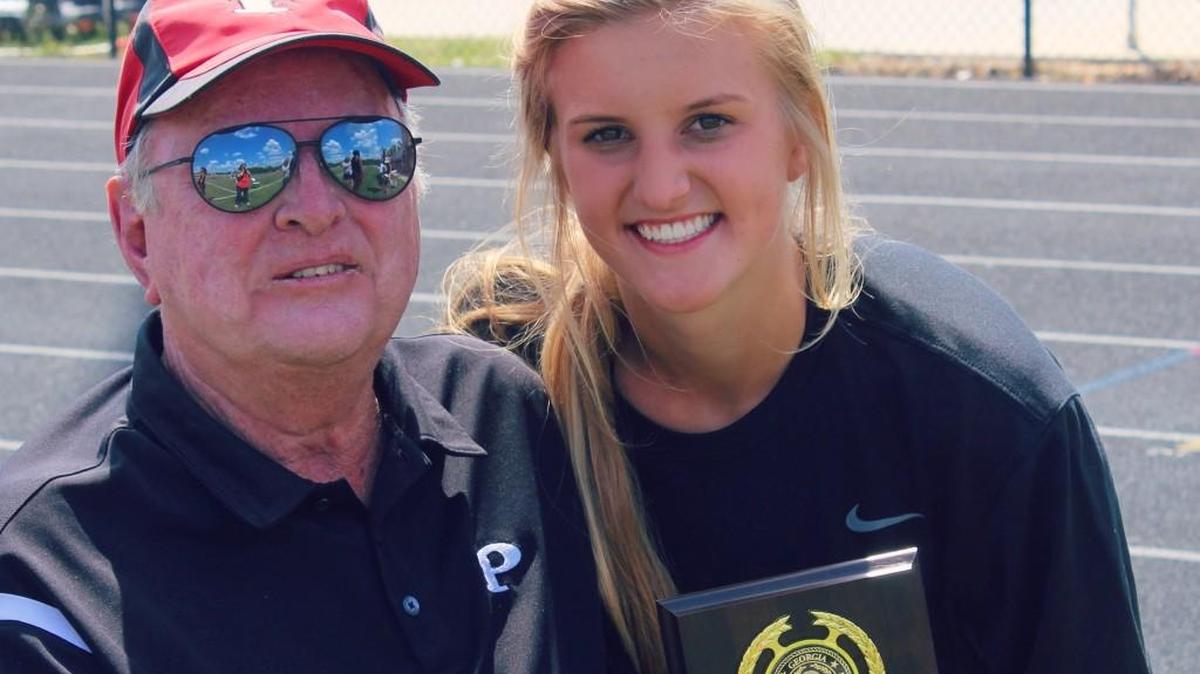 Sadie Frame poses for a photo with her grandfather, Dick Frame.