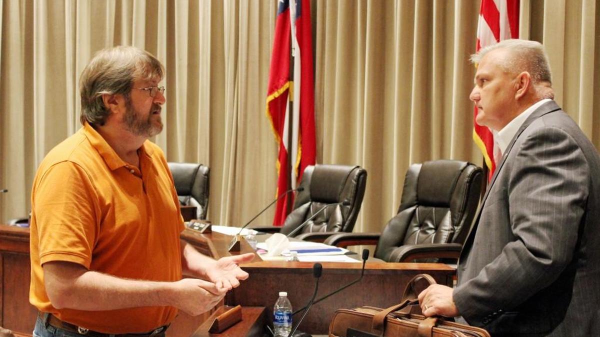 Dean Cowart, left, speaks to Warner Robins Councilman Tim Thomas after a recent council meeting. Cowart says he plans to run for the at-large post held by Chuck Shaheen.