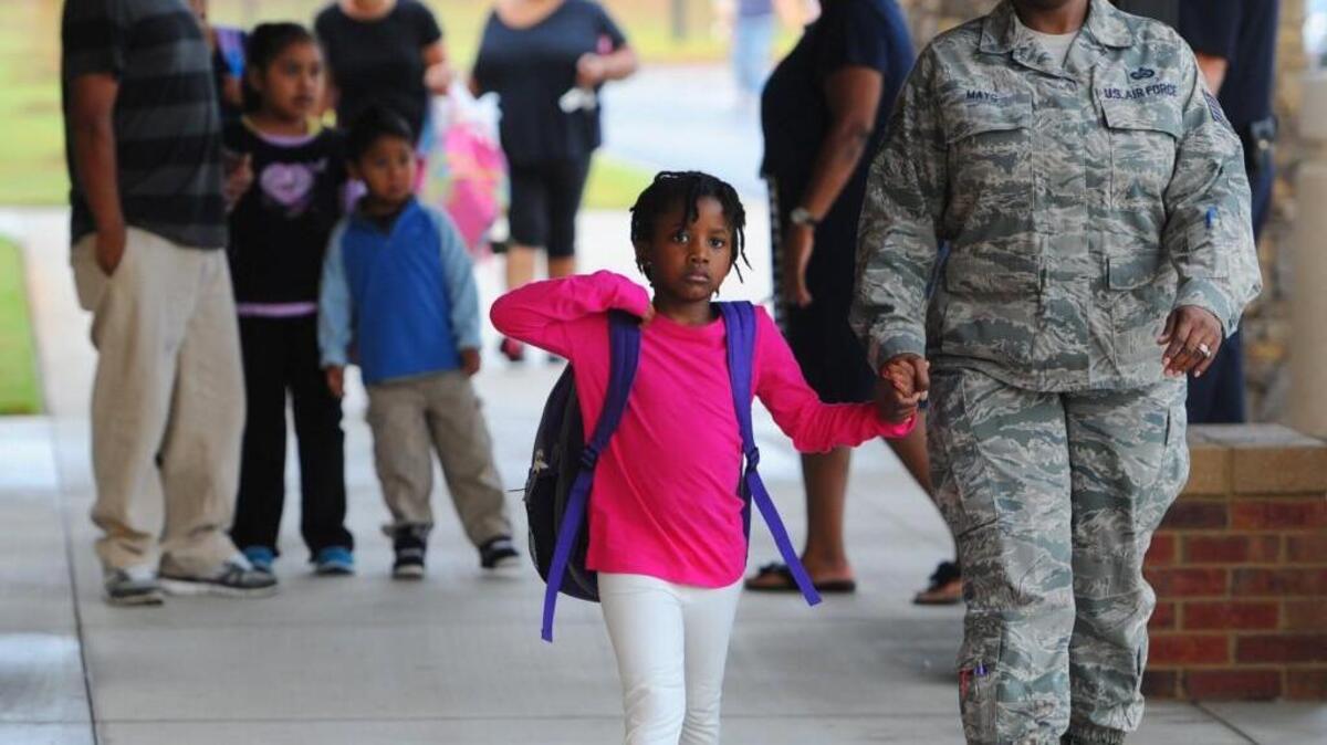 Jaukena Mays holds her 5-year-old daughter's, Kaitelyn, hand as they arrive at Watson Primary in Warner Robins for the first day of school in Houston County in this 2013 file photo.