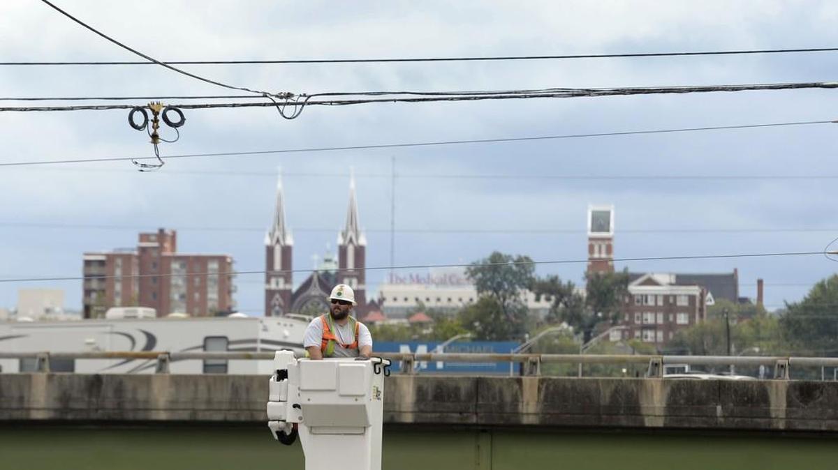 Macon-Bibb County employee Shannon Callaway installs a new light on Spring Street Sept. 12, 2017, where winds from tropical storm Irma knocked an old one down.