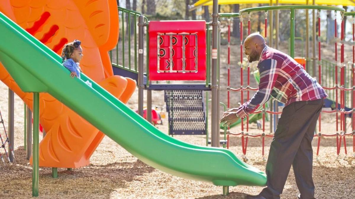 Broderick Jackson waits on his niece Lydia Wright, 2, at the bottom of the slide after a ribbon-cutting ceremony at Filmore Thomas Park on Monday. Jackson is the grandson and Wright is the great-granddaughter of Thomas. A grand opening ceremony for the park will be held Saturday, Nov. 12, 2016.