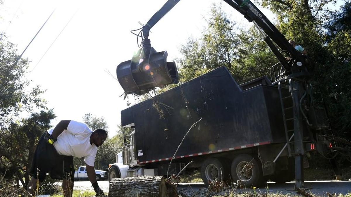A crew picks up Hurricane Irma debris from a yard in south Macon on Nov. 6.