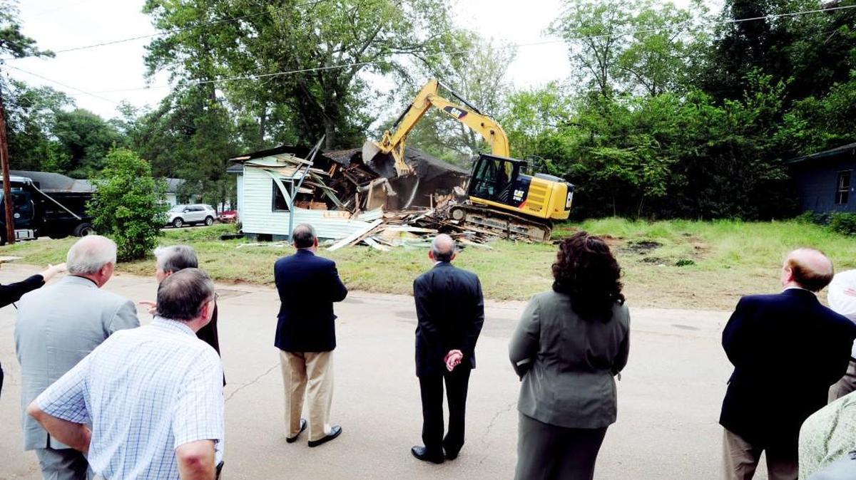 In this Sept. 30, 2014, Telegraph file photo, Macon-Bibb County commissioners watch a public works crew demolish an abandon house at 4244 Pinson St. Macon-Bibb is now seeking a new County Manager, who would oversee 1,800 employees and work closely with the County Commission.