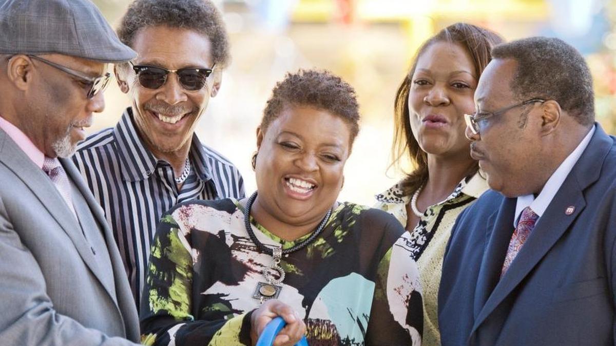 Alfreda Lockett, center, daughter of Filmore Thomas cracks a smile after cutting the ribbon during a ceremony to dedicate Filmore Thomas Park on Nov. 7, 2016.