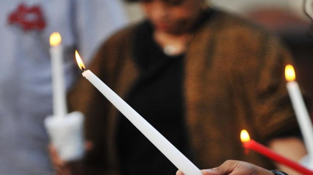 In this Telegraph file photo, candles burn for Terrilyn Williams at the spot where she was gunned down and killed on during a September 2010 remembrance of her. A memorial service for victims of gun violence will be held in Macon on June 12, 2017.