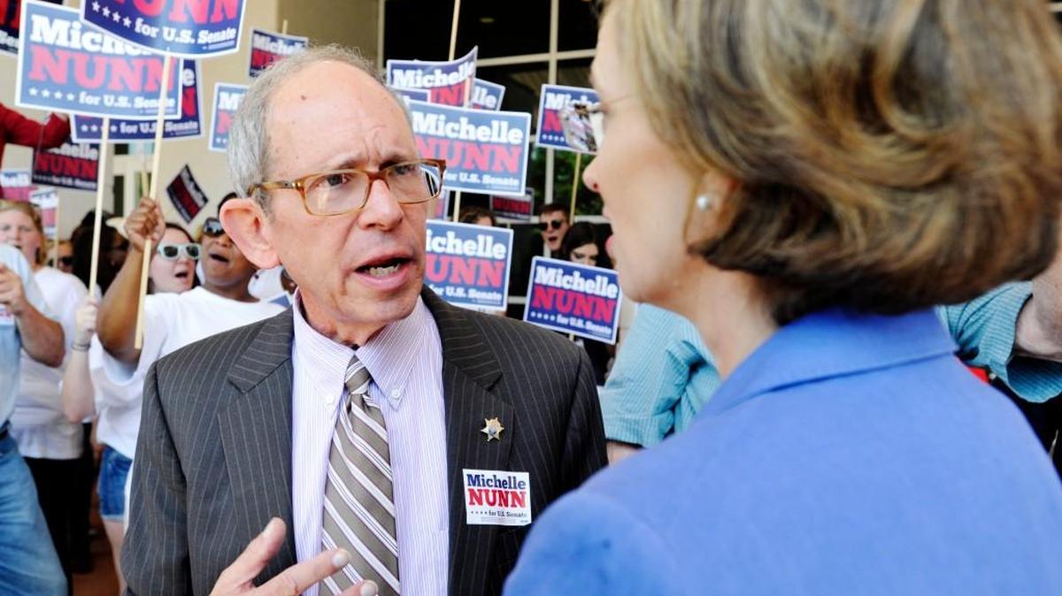 Macon-Bibb County Commissioner Larry Schlesinger talks with Democratic nominee Michelle Nunn after an Aug. 21, 2014, forum with Republican nominee David Perdue at the Macon Convention Center.