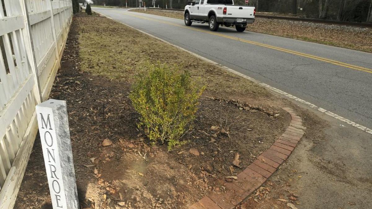 A stone county line marker on Rivoli Drive near Old Forsyth Road.