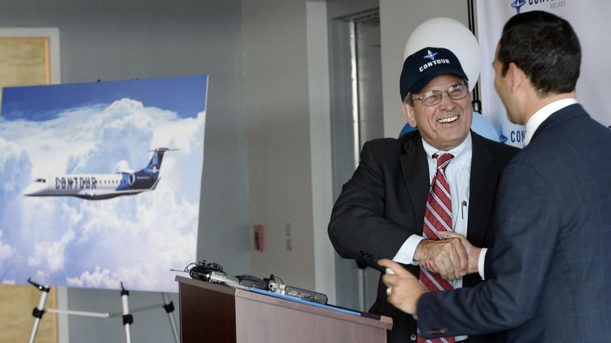 Macon Mayor Robert Reichert, left, donned a Contour Airlines cap after a July 12 news conference announcing regularly scheduled service between Macon and Washington, DC starting August 17th.