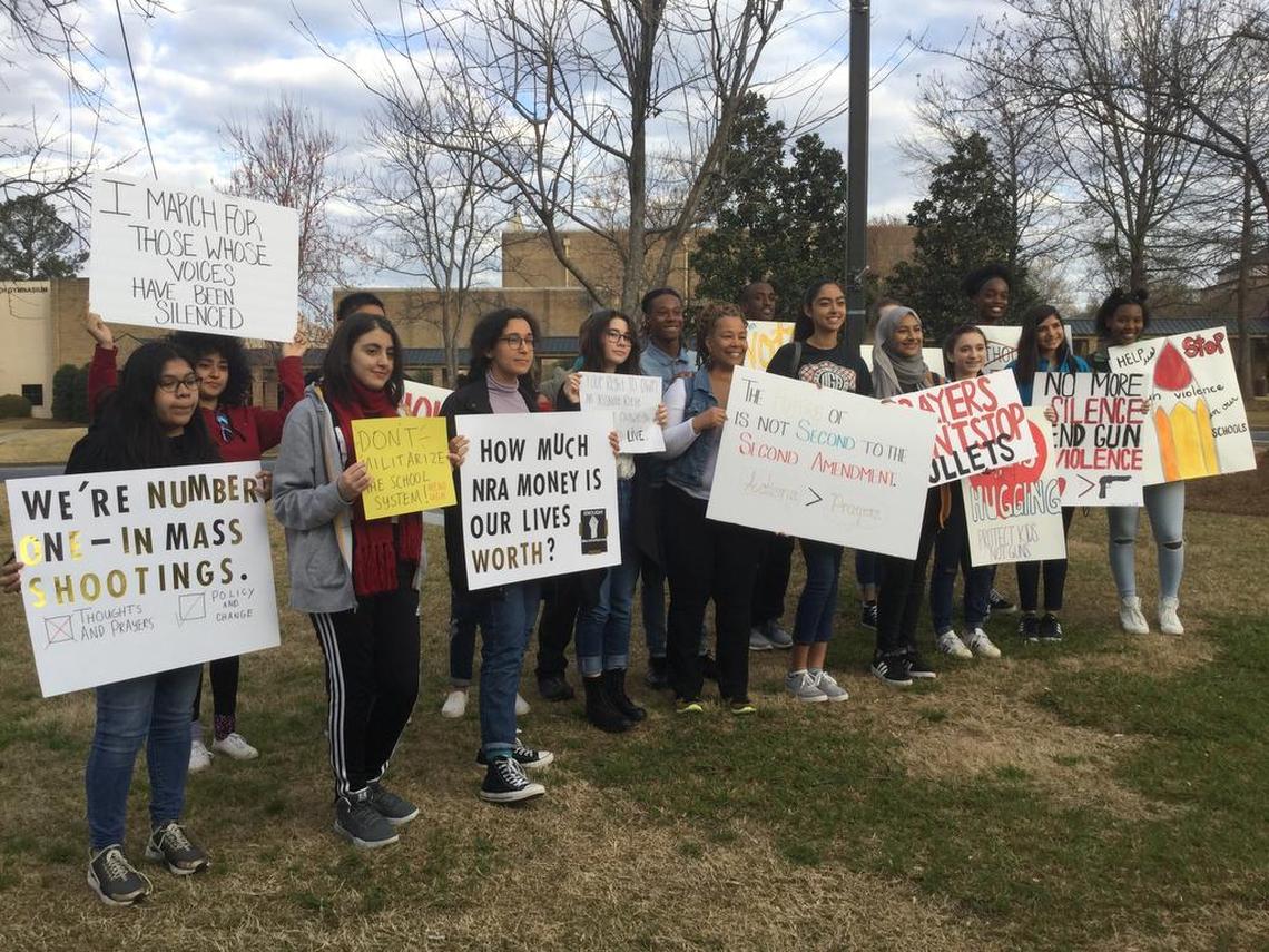 Midstate students show off their signs at Stratford Academy in Macon ahead of the March for Our Lives march and rally in Atlanta on Saturday.