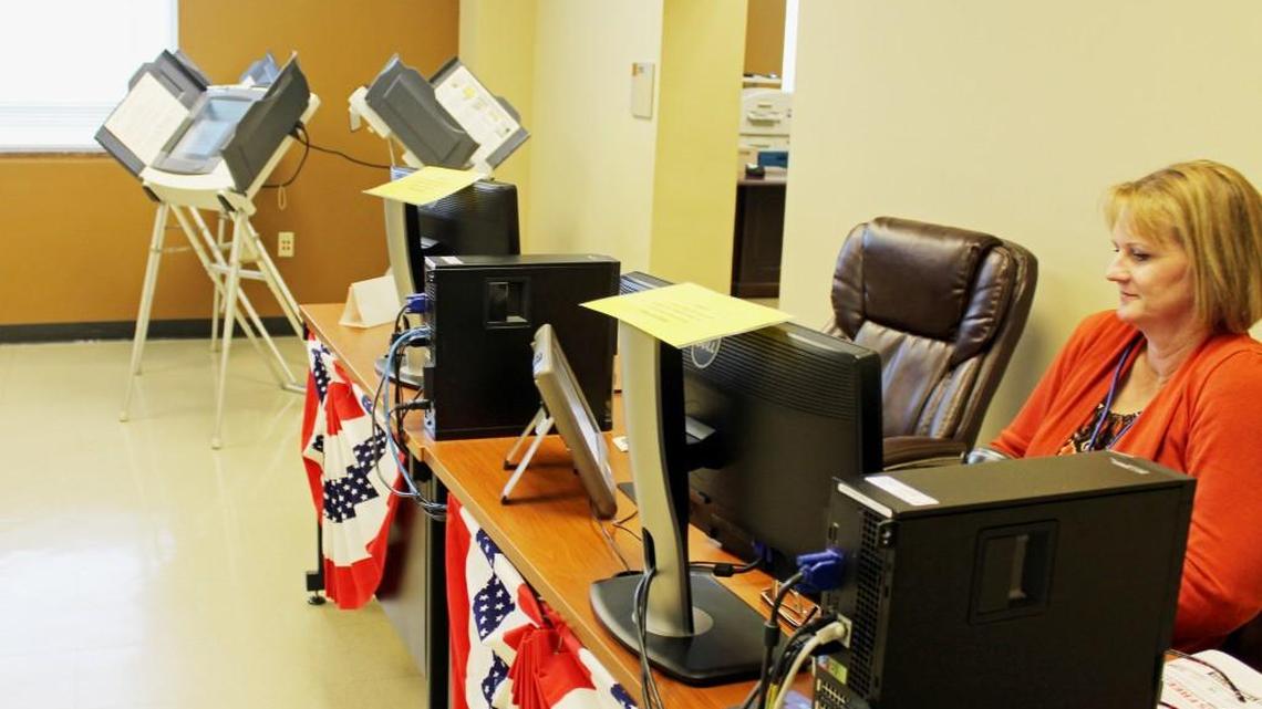 Poll worker Robin Way waits for voters at the old Houston County Courthouse in Perry on Monday as early voting opened with light turnout.