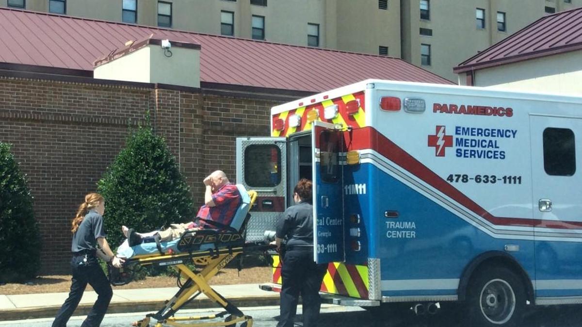 Michael Summer, 56, is loaded into an ambulance Friday morning after he was hit by a car while riding his motorized cart into the parking lot of McAfee Towers, where he lives at 1212 Gray Highway.
