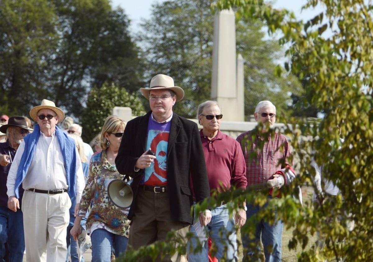 Phil Comer, center, will lead Sunday’s Rose Hill Ramble that will visit graves of the Allman Brothers and the slain Woolfolk family from 1887.