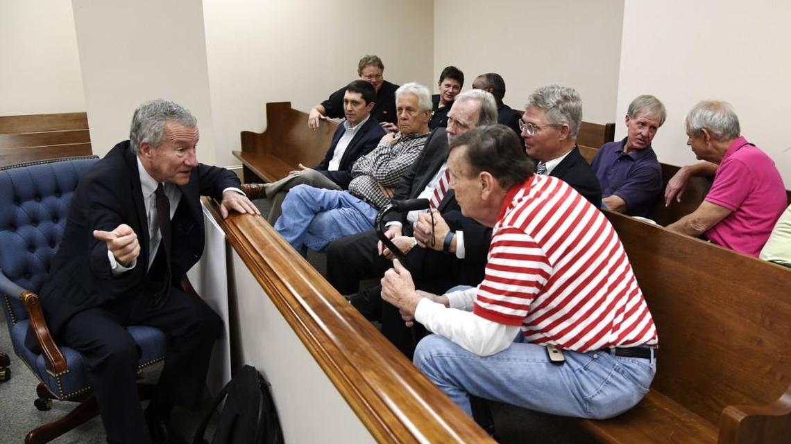 Former congressman and Macon Mayor Jim Marshall talks with people in the gallery before a hearing begins Wednesday concerning the Macon Health Club. Marshall is one of the people fighting to keep the downtown Macon club open.